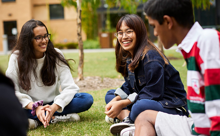 Students soclialising on the grass